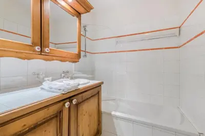 a bathroom with a sink and a bath tub at Résidence Les Fermes du Soleil - maeva Home - 3 pièces 6 pers Sélection MAE-5543 in Les Carroz d'Araches