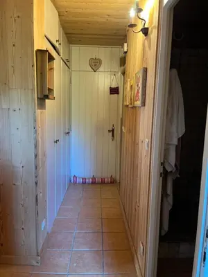a hallway with wood paneling and a tile floor at Appartement cosy, esprit chalet avec jolie vue in Saint-Gervais-les-Bains