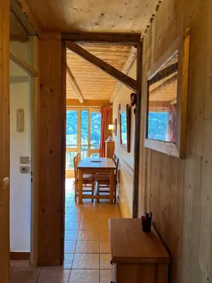 a kitchen with red cabinets and a sink at Appartement cosy, esprit chalet avec jolie vue in Saint-Gervais-les-Bains