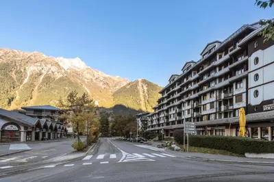 an empty street in front of a mountain at L'Aiguille - maeva Home - Appartement 2 pièces 5 personnes Confort MAE-2197 in Chamonix-Mont-Blanc
