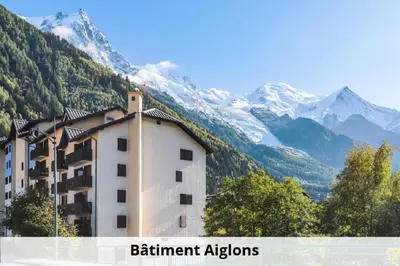 a building in front of a mountain with snow at L'Aiguille - maeva Home - Appartement 2 pièces 5 personnes Confort MAE-2197 in Chamonix-Mont-Blanc