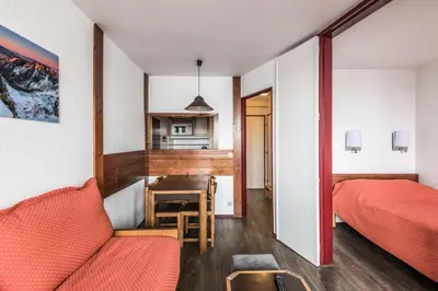 a room with a bed and a table and a kitchen at L'Aiguille - maeva Home - Appartement 2 pièces 5 personnes Confort MAE-2197 in Chamonix-Mont-Blanc