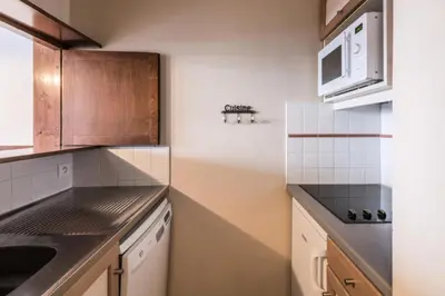 a kitchen with a sink and a microwave at L'Aiguille - maeva Home - Appartement 2 pièces 5 personnes Confort MAE-2197 in Chamonix-Mont-Blanc
