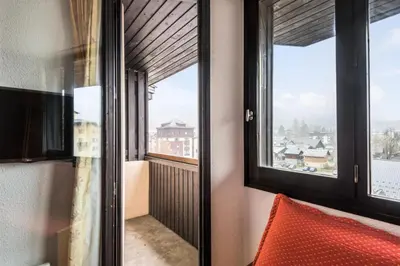 a room with a window with a view of a city at L'Aiguille - maeva Home - Appartement 2 pièces 5 personnes Confort MAE-2197 in Chamonix-Mont-Blanc