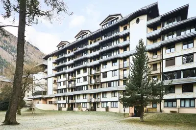 a large building with a tree in front of it at L'Aiguille - maeva Home - 2 Pièces 5 Personnes - Sélection MAE-4175 in Chamonix-Mont-Blanc