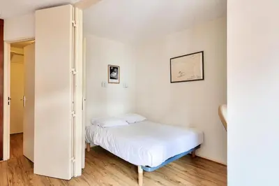 a small bedroom with a bed and a closet at L'Aiguille - maeva Home - 2 Pièces 5 Personnes Sélection MAE-1179 in Chamonix-Mont-Blanc