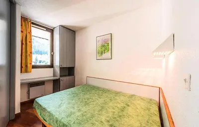 a bedroom with a bed in a room with a window at L'Aiguille - maeva Home - 2 Pièces 5 Personnes Confort MAE-1176 in Chamonix-Mont-Blanc
