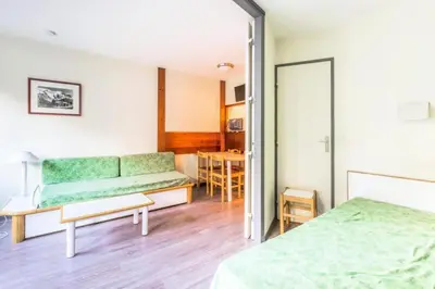 a room with two beds and a couch at L'Aiguille - maeva Home - 2 Pièces 5 Personnes Confort MAE-2139 in Chamonix-Mont-Blanc