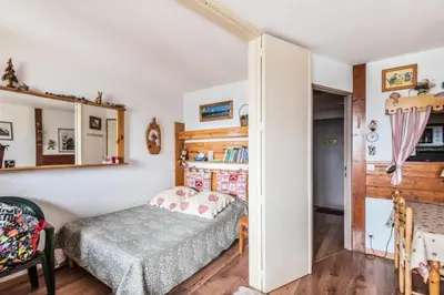 a bedroom with a bed and a book shelf at L'Aiguille - maeva Home - Appartement 2 pièces 5 personnes Confort MAE-2592 in Chamonix-Mont-Blanc