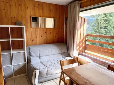 a small living room with a couch and a table at Résidence Arche - Studio confortable · Centre station · Terrasse MAE-5084 in Magland