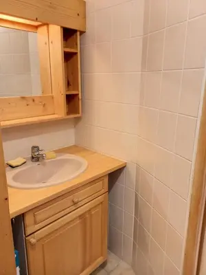 a bathroom with a sink and a mirror at Résidence Arche - Studio confortable · Centre station · Terrasse MAE-5084 in Magland