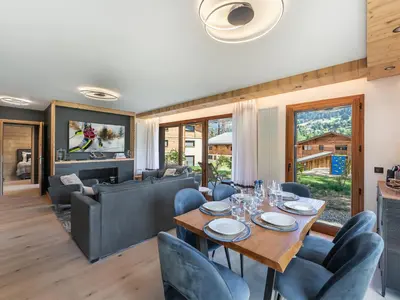 a dining room with a table and chairs at Appartement neuf, 4 personnes, terrasse, 15 min du centre de Megève - FR-1-569-96 in Megève