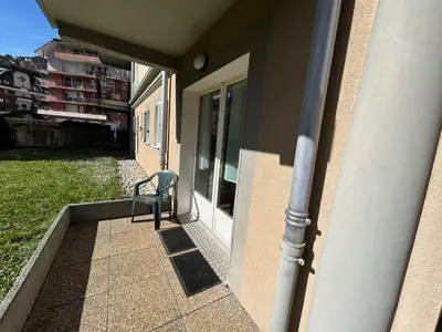 a chair sitting on the porch of a house at Residence le Grand Panorama - with garden & view in Saint-Gervais-les-Bains