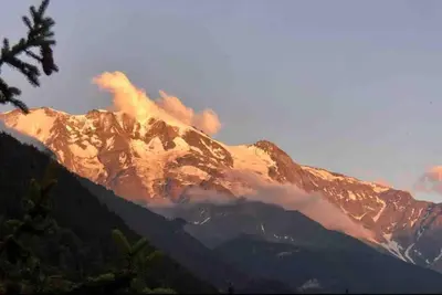 a mountain with smoke coming out of it at Residence le Grand Panorama - with garden & view in Saint-Gervais-les-Bains