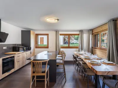 a kitchen and dining room with a long table and chairs at Spacieux appartement pour familles près du centre avec parking - FR-1-569-85 in Megève