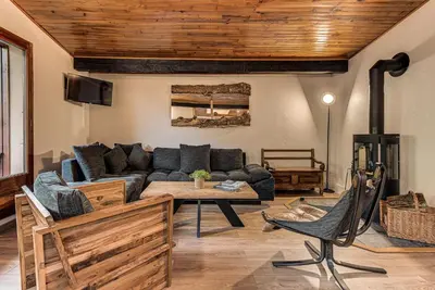 a living room with a couch and a table at Apartment Les Nantillons - Alpes Travel - Central Chamonix (sleeps 6-8) in Chamonix-Mont-Blanc