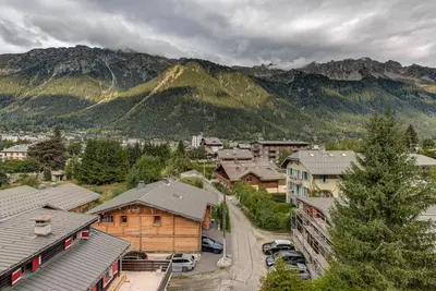 a town with houses and a mountain in the background at Apartment Les Nantillons - Alpes Travel - Central Chamonix (sleeps 6-8) in Chamonix-Mont-Blanc