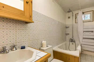 a bathroom with a tub and a sink and a toilet at Apartment Les Nantillons - Alpes Travel - Central Chamonix (sleeps 6-8) in Chamonix-Mont-Blanc
