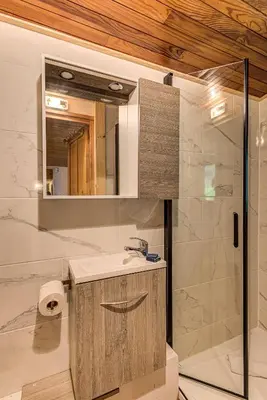 a bathroom with a sink and a mirror at Apartment Les Nantillons - Alpes Travel - Central Chamonix (sleeps 6-8) in Chamonix-Mont-Blanc