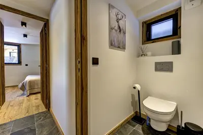 a bathroom with a toilet and a window at Chalet Silver Forest in Chamonix-Mont-Blanc
