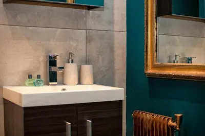 a bathroom with a white sink and a mirror at Beautiful cosy, modern studio in Chamonix centre in Chamonix-Mont-Blanc