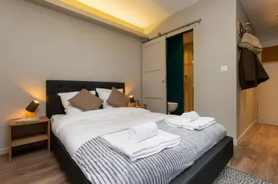 a bedroom with a large bed with towels on it at Beautiful cosy, modern studio in Chamonix centre in Chamonix-Mont-Blanc