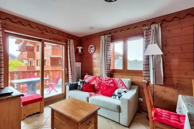 a living room with a couch and a table at Résidence Les Fermes du Soleil - maeva Home - Appartement 3 pièces 6 personnes - Prestige MAE-0374 in Les Carroz d'Araches