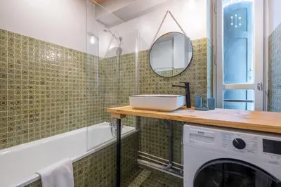 a bathroom with a washing machine and a mirror at La Rose de Glace in Chamonix-Mont-Blanc