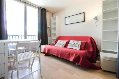 a bedroom with a red bed with a red blanket at Studio Cabine Sud, centre de Flaine, linge et menage compris in Flaine
