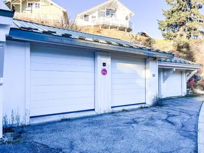 a pair of white garage doors in a driveway at Charming 4-bed Chalet, Mountain Views, Double Garage in Flaine