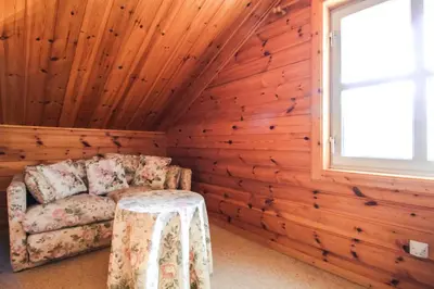a room with a chair and a table at Charming 4-bed Chalet, Mountain Views, Double Garage in Flaine