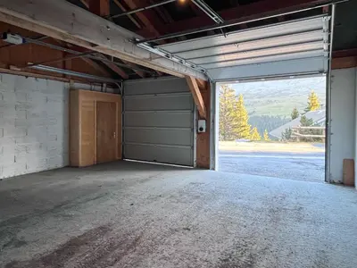 an empty garage with a door and a large window at Charming 4-bed Chalet, Mountain Views, Double Garage in Flaine