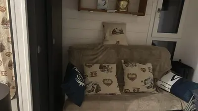 a small bed in a room with pillows at LE GL'ASSIE in Saint-Gervais-les-Bains