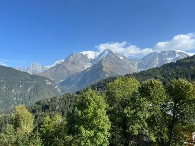 a view of a mountain range with snow capped mountains at LE GL'ASSIE in Saint-Gervais-les-Bains
