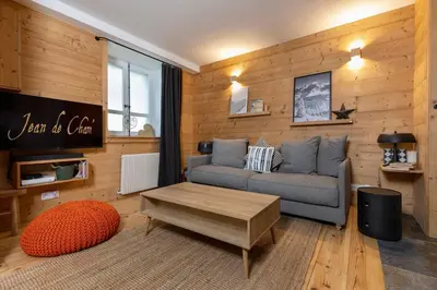 a living room with a couch and a coffee table at Le Refuge du Lyret - 2 Pers - Rénové in Chamonix-Mont-Blanc