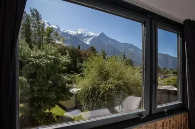 a window with a view of a snow covered mountain at Modern apartment with the best Mont Blanc view! in Chamonix-Mont-Blanc