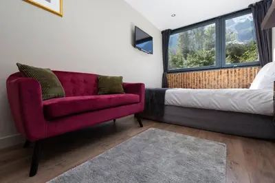 a room with a couch and a bed and a window at Modern apartment with the best Mont Blanc view! in Chamonix-Mont-Blanc