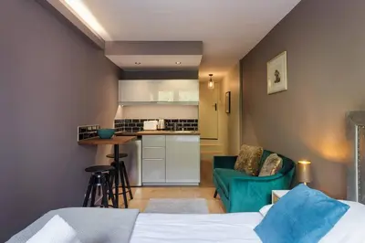 a bedroom with a bed and a kitchen with a counter at Fantastic studio by the lake with Mountain View in Chamonix-Mont-Blanc