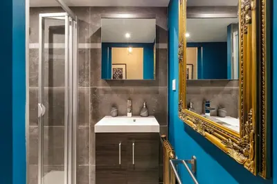 a bathroom with a sink and a mirror at Fantastic studio by the lake with Mountain View in Chamonix-Mont-Blanc