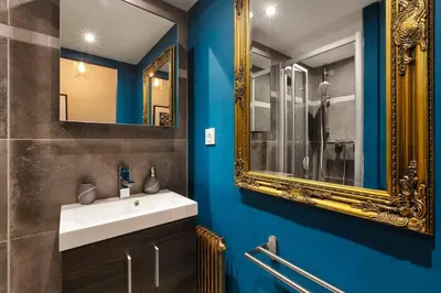 a bathroom with a sink and a mirror at Fantastic studio by the lake with Mountain View in Chamonix-Mont-Blanc