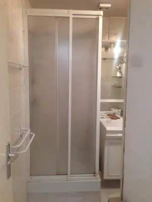 a glass shower in a bathroom with a sink at Appartment Aiguille Du Midi in Chamonix-Mont-Blanc