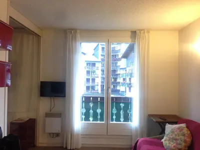 a room with a sliding glass door with a window at Appartment Aiguille Du Midi in Chamonix-Mont-Blanc