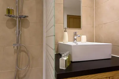 a bathroom with a sink and a shower at Apartment Chamois Blanc 2 Centre Chamonix Mont Blanc in Chamonix-Mont-Blanc