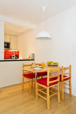 a kitchen and dining room with a wooden table and chairs at Apartment Chamois Blanc 2 Centre Chamonix Mont Blanc in Chamonix-Mont-Blanc