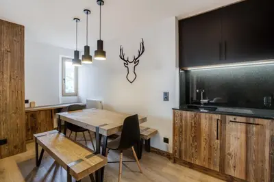 a dining room with a table and a blackboard at Appartement 2 chambres en centre-ville de Megève in Megève
