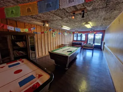 a billiard room with a pool table and a table at Hotel et centre de vacances Le Choucas in Sixt