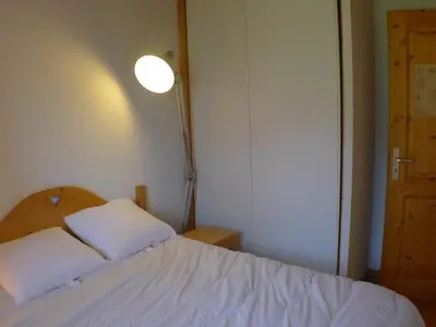 a bedroom with a bed with two white pillows at Duplex T4 calme avec parking, animaux acceptés à Samoëns - FR-1-629-133 in Samoëns