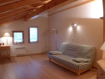a living room with a couch and a table at Duplex T4 calme avec parking, animaux acceptés à Samoëns - FR-1-629-133 in Samoëns