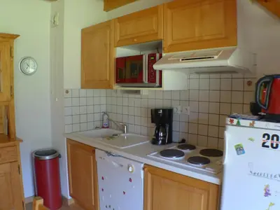 a kitchen with a sink and a stove at Duplex T4 calme avec parking, animaux acceptés à Samoëns - FR-1-629-133 in Samoëns