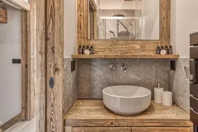 a bathroom with a white sink and a mirror at Chalet BelleVue in Chamonix-Mont-Blanc